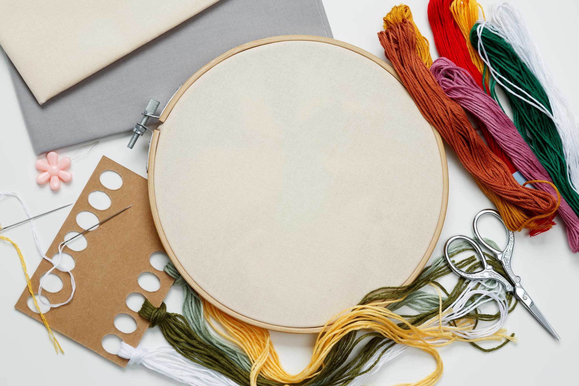 Workshop table with threads and embroidery hoops